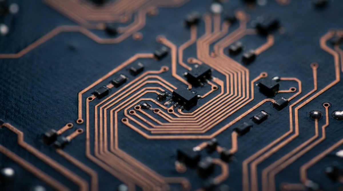 Macro photograph of a navy circuit board with copper traces